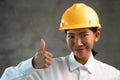 Portrait of smiling Asian woman engineer showing thumbs up gesture Royalty Free Stock Photo