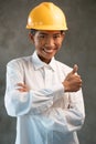 Portrait of smiling Asian woman engineer showing thumbs up gesture Royalty Free Stock Photo