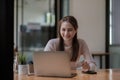 Portrait smiling asian woman resting and shopping online at home, Happy woman using laptop and credit card for online Royalty Free Stock Photo