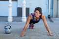 Portrait of smiling athletic woman doing push-ups Royalty Free Stock Photo