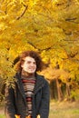 Portrait of smiling attractive man dressed in striped sweater, oudoor in autumn park Royalty Free Stock Photo