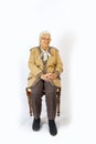 Portrait of smiling attractive senior woman sitting on a chair Royalty Free Stock Photo