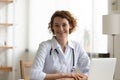 Portrait of smiling attractive trusted young female general practitioner. Royalty Free Stock Photo