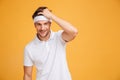 Portrait of smiling attractive young man athlete in headband Royalty Free Stock Photo
