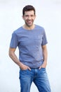 Smiling attractive young man standing with hands in his pocket on white background Royalty Free Stock Photo