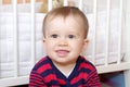 Portrait of smiling baby against white bed Royalty Free Stock Photo