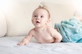 Portrait of adorable smiling baby boy lying on bed after having bath Royalty Free Stock Photo