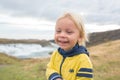 Portrait of a smiling baby boy near smaller waterfall around Gullfoss, Iceland Royalty Free Stock Photo