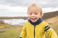 Portrait of a smiling baby boy near smaller waterfall around Gullfoss, Iceland Royalty Free Stock Photo