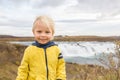 Portrait of a smiling baby boy near smaller waterfall around Gullfoss, Iceland Royalty Free Stock Photo