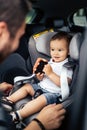 Portrait of smiling baby and father in car child seat Royalty Free Stock Photo