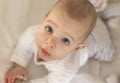 Portrait of a smiling baby laying on a changing table Royalty Free Stock Photo