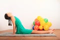 Portrait of pretty girl stretching on grey carpet Royalty Free Stock Photo