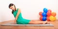 Portrait of pretty girl stretching on grey carpet Royalty Free Stock Photo