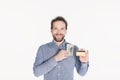 portrait of smiling bearded man with dollar banknotes in pocket showing credit card in hand Royalty Free Stock Photo