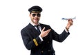 portrait of smiling bearded pilot in uniform pointing at toy plane in hand