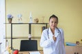 Portrait of smiling beautiful asian woman doctor showing thumps up sign at hospital,Happy and positive attitude Royalty Free Stock Photo