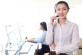 Portrait of smiling beautiful Asian woman with headphones work at call center service desk consultant, call center operator agent Royalty Free Stock Photo