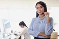 Portrait of smiling beautiful Asian woman with headphones work at call center service desk consultant, call center operator agent Royalty Free Stock Photo