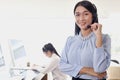 Portrait of smiling beautiful Asian woman with headphones work at call center service desk consultant, call center operator agent Royalty Free Stock Photo