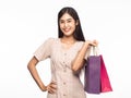 Portrait of smiling beautiful asian woman wearing dress and holding shopping bags isolated on white background. Royalty Free Stock Photo