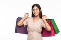 Portrait of smiling beautiful asian woman wearing dress and holding shopping bags isolated on white background. Royalty Free Stock Photo