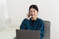 Portrait of smiling beautiful business asian woman using laptop computer and calling byh mobile phone from home concept Royalty Free Stock Photo