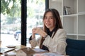 Portrait of smiling beautiful business asian woman working in office use computer. looking camera. Royalty Free Stock Photo