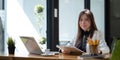 Portrait of smiling beautiful business asian woman working in office use computer. looking camera. Royalty Free Stock Photo