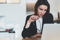 Portrait of Smiling beautiful businesswoman using laptop computer at modern office.Blurred background.Horizontal. Royalty Free Stock Photo