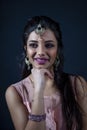 Portrait of smiling beautiful indian girl wearing traditional purple clothes Royalty Free Stock Photo