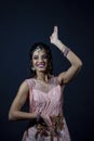 Portrait of smiling beautiful indian girl wearing traditional purple clothes Royalty Free Stock Photo