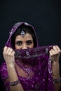 Portrait of smiling beautiful indian girl wearing traditional purple clothes Royalty Free Stock Photo