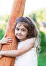 Portrait of smiling beautiful little girl at green of summer par Royalty Free Stock Photo