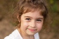 Portrait of smiling beautiful little girl at summer park. Cute child looking at the camera Royalty Free Stock Photo