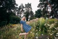 A portrait of a smiling beautiful slender girl with blond long hair holding wildflowers Royalty Free Stock Photo