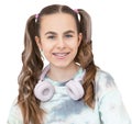 Portrait of smiling beautiful teenage girl with braces listening music in headphones, audiobook, lecture Royalty Free Stock Photo