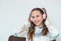 Portrait of smiling beautiful teenage girl with braces listening music in headphones, audiobook, lecture Royalty Free Stock Photo