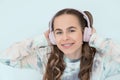 Portrait of smiling beautiful teenage girl with braces listening music in headphones, audiobook, lecture Royalty Free Stock Photo