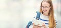 Portrait of a smiling beautiful teenage girl with dental braces. Young schoolgirl with school bag and tablet device Royalty Free Stock Photo