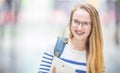 Portrait of a smiling beautiful teenage girl with dental braces. Young schoolgirl with school bag and tablet device Royalty Free Stock Photo