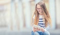 Portrait of a smiling beautiful teenage girl with dental braces. Young schoolgirl with school bag and tablet device Royalty Free Stock Photo