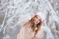 Portrait of smiling beautiful woman in a beige coat in a winter Royalty Free Stock Photo