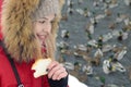 Portrait of smiling beautiful young girl in red jacket with hood and fur close - up Royalty Free Stock Photo