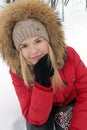 Portrait of smiling beautiful young girl in red jacket Royalty Free Stock Photo