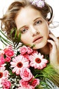 Portrait of miling beautiful young woman with bouquet flowers