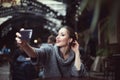 Portrait of a smiling beautiful young woman making selfie photo with her smartphone Royalty Free Stock Photo