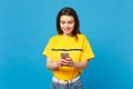 Portrait of smiling beautiful young woman in vivid casual clothes using mobile phone typing sms message isolated on Royalty Free Stock Photo
