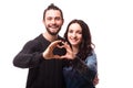 Portrait of smiling beauty girl and her handsome boyfriend making shape of heart by their hands.