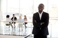 Portrait of smiling black businessman standing posing in office Royalty Free Stock Photo